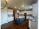 Bright kitchen featuring stainless steel appliances, a gray island, and hardwood floors at 320 Willow Cv, Canton, GA 30114