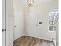 Entryway featuring stylish wood-look floors, neutral walls, and a convenient coat closet for storage at 3815 Pleasant Oaks Dr, Lawrenceville, GA 30044