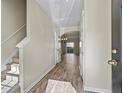 Inviting foyer with light-colored walls, wood-look floors, stairs, and an arched opening leading to the living area at 3815 Pleasant Oaks Dr, Lawrenceville, GA 30044