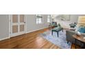 Comfortable living room featuring hardwood floors, a gray sofa and soft natural light at 422 Derbyshire Dr, Stone Mountain, GA 30088