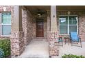 Inviting front porch with brick columns and a cozy seating area at 5310 Corinth Ct, Cumming, GA 30040