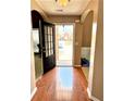 Inviting entryway with hardwood floors, arched doorways, and a glimpse of the home's exterior at 3345 Stoneleigh Run Dr, Buford, GA 30519