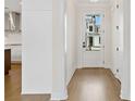 Bright entryway with hardwood floors, a glass panel front door and white trim at 537 Pearl St, Cumming, GA 30040
