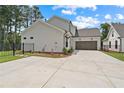 Two-story home with two-car garage, spacious driveway, and manicured lawn and back yard at 537 Pearl St, Cumming, GA 30040