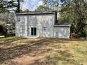 The home's back exterior showcases a sliding glass door and an ample backyard at 5463 Forest East Ln, Stone Mountain, GA 30088