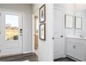Hallway with access to the front door, powder room, and a view into the living area at , Acworth, GA 30102