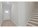 Entryway with hardwood floors, white door with glass, and a staircase leading to the second floor at 4667 Larkfield Way, Powder Springs, GA 30127