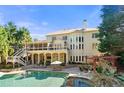 Beautiful backyard featuring a pool, a spa, a pergola, a patio, and a covered deck offering outdoor living spaces at 5120 Parkwood Oaks Ln, Smyrna, GA 30126