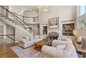 Spacious living room with soaring ceilings, a grand staircase, built-in shelving, and stylish furniture at 5120 Parkwood Oaks Ln, Smyrna, GA 30126