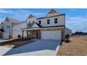 Charming two-story house featuring a brick and white facade, covered entryway, and a two-car garage at 3941 Adler Cir, Buford, GA 30519