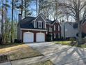 Charming two-story home featuring a brick facade and two-car garage at 3954 Lullwater Main Nw, Kennesaw, GA 30144