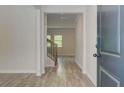 Light and airy entryway featuring wood-look floors and staircase in a modern home at 4524 Ajo Walk, Atlanta, GA 30331