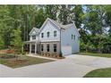 Side view of a blue two-story home with attached garage and concrete driveway at 4524 Ajo Walk, Atlanta, GA 30331