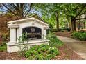 Elegant Carrington Park at Lenox Condominiums sign with manicured landscaping and a sidewalk leading to the community at 2700 Pine Tree Ne Rd # 1117, Atlanta, GA 30324