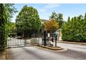 Secure gated entrance to the property featuring black iron gates and well-maintained landscaping at 2700 Pine Tree Ne Rd # 1117, Atlanta, GA 30324