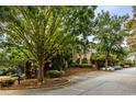 Well-maintained parking area with assigned spaces surrounded by mature trees and landscaping at 2700 Pine Tree Ne Rd # 1117, Atlanta, GA 30324