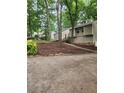 Inviting home featuring fresh mulch and a paved driveway amongst a scenic wooded landscape at 6739 Valley Ct, Douglasville, GA 30135
