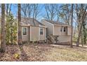 Charming home with fresh landscaping, mature trees, and a welcoming front entrance at 6739 Valley Ct, Douglasville, GA 30135