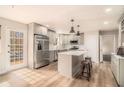 Bright, renovated kitchen featuring modern appliances, a center island, and hardwood floors at 6739 Valley Ct, Douglasville, GA 30135