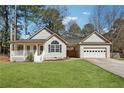 Inviting single-story home with a covered porch, attached garage, and a neatly landscaped front yard at 140 Double D Rd, Temple, GA 30179