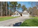 Attractive single-story home with a covered entry, attached garage, and long driveway at 140 Double D Rd, Temple, GA 30179
