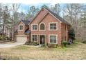 Beautiful two-story red brick home with a manicured lawn and a two car garage at 1705 Butler Bridge Rd, Covington, GA 30016