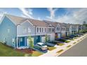 New townhome exteriors featuring diverse color palettes, single-car garages, and landscaped sidewalks at 4283 Notting Hill Dr # 66, Atlanta, GA 30331