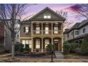 Charming two-story home featuring a double porch viewed at dusk at 1596 Baxley Pine Trce, Suwanee, GA 30024