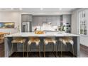Modern kitchen with gray cabinets, stainless steel appliances, and a large island with seating at 215 Arizona Ne Ave # 1, Atlanta, GA 30307