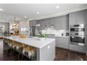 Open concept kitchen with gray cabinets, stainless steel appliances, and center island at 215 Arizona Ne Ave # 1, Atlanta, GA 30307