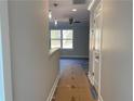 Hallway features modern lighting, neutral paint, and flooring leading to a living area at 229 Evergreen Trail Unit C, Cartersville, GA 30121