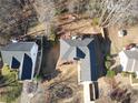 A high angle aerial of the home and surrounding landscape with mature trees at 70 Trelawney Cir, Covington, GA 30016