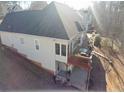 Back view showcasing a home with a two-story deck and a wooded backdrop at 70 Trelawney Cir, Covington, GA 30016