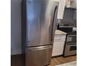 Stainless steel refrigerator with bottom freezer, next to range in kitchen at 3060 Pharr Court North Nw # 306, Atlanta, GA 30305