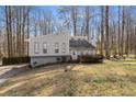 Split level home featuring unique design, driveway, and large trees at 3747 Junior Ln, Douglasville, GA 30135