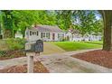 Quaint one-story home featuring a lush lawn, traditional architecture, and street mailbox at 1132 Fair St, Atlanta, GA 30314