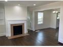 Spacious living room with a fireplace, hardwood floors, and natural light at 1132 Fair St, Atlanta, GA 30314