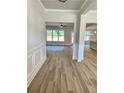 Inviting foyer featuring beautiful wood floors and wainscoting detail at 1715 Crumbley Rd, Mcdonough, GA 30252