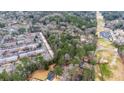 Aerial view showcasing the wooded area adjacent to townhomes and other residences, offering building possibilities at 2469 Stone Rd, East Point, GA 30344
