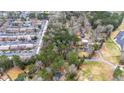 Aerial view showing the wooded parcel alongside townhomes, neighborhood pool, and additional homes at 2469 Stone Rd, East Point, GA 30344