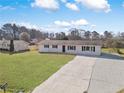 Aerial view of the home featuring a spacious front yard, long driveway and an additional building in the back at 708 Morris Rd, Hiram, GA 30141