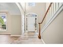 Welcoming foyer with beautiful wood-look tile flooring and a staircase with white railings at 217 Park Creek Dr, Woodstock, GA 30188