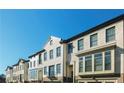 Row of bright townhouses with manicured lawns, garages, and lots of windows at 4191 Wisconsin Dr, Dunwoody, GA 30338