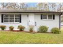 Inviting single-Gathering home with dark shutters, a bright white door, and a landscaped yard at 4611 Old Westside Rd, Austell, GA 30106