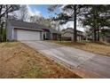 Exterior view of a well-maintained home with a spacious driveway in a suburban setting at 4938 Terrace Green Trce, Stone Mountain, GA 30088