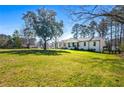 Large front lawn featuring a white home, mature trees, and a lush green yard at 2120 Blaylock Dr, Marietta, GA 30062