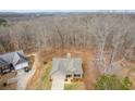 Aerial view of a home with a two car garage nestled in a wooded area at 248 Oaken Bucket Dr, Temple, GA 30179