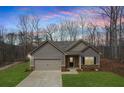 Beautifully landscaped home with lush green lawn, stone accents, and a two-car garage at 248 Oaken Bucket Dr, Temple, GA 30179