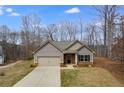 Inviting single-Gathering home showcasing a well-maintained lawn and a two-car garage at 248 Oaken Bucket Dr, Temple, GA 30179