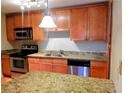 Kitchen featuring stainless steel appliances, light wood cabinets, and granite countertops at 2657 Lenox Rd # F84, Atlanta, GA 30324